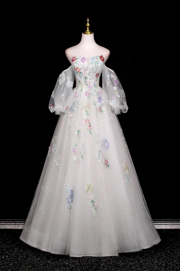 Elegant evening gown with floral embroidery on a mannequin against a black background