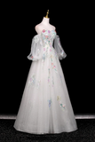 Elegant white gown with floral embroidery on a mannequin against a black background