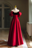 Red evening gown on a mannequin in an indoor setting