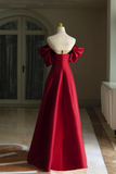 Red evening gown on a mannequin against a neutral background