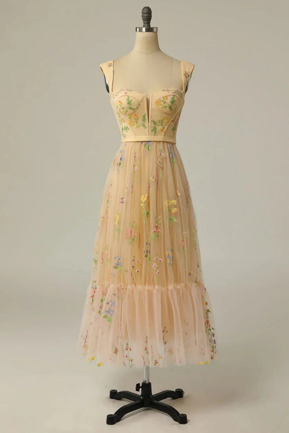 Beige floral dress on a mannequin against a plain background