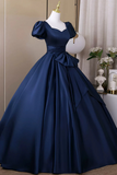 Navy blue ball gown on a mannequin against a neutral background