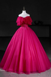 Fuchsia evening gown on a mannequin against a dark background