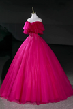 Fuchsia evening gown on a mannequin against a dark background