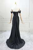 Black evening gown on a mannequin against a white background