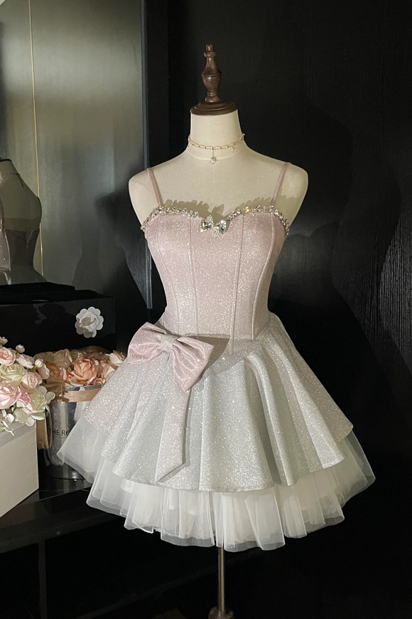 Pink and white dress on a mannequin against a dark background