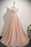 Beige evening gown on a mannequin against a plain background