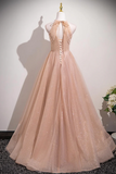 Beige evening gown on a mannequin against a plain background