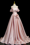 Pink evening gown on a mannequin against a black background