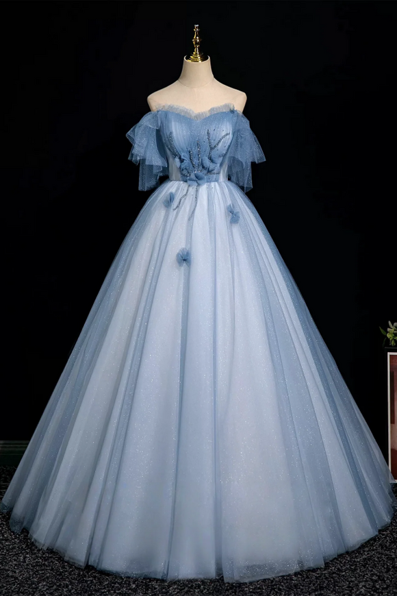 Light blue evening gown on a mannequin against a black background