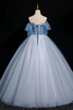 Blue and white ball gown on a mannequin against a black background