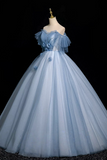 Light blue ball gown on a mannequin against a black background