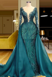 Teal evening gown with long sleeves on a mannequin in an indoor setting.