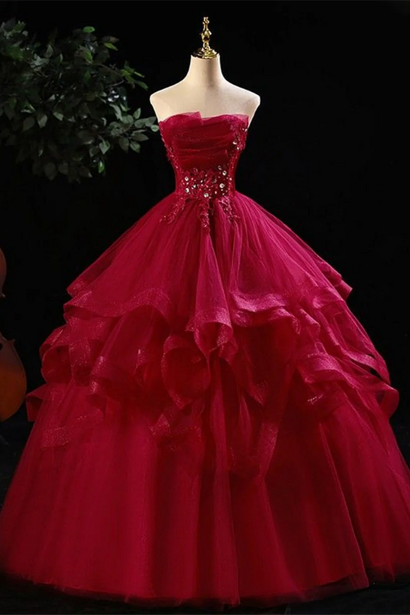 Red ball gown on a mannequin against a dark background