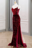Red sequin evening gown on a mannequin against a neutral background