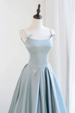 Light blue evening gown on a mannequin against a white background