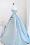 Light blue evening gown on a mannequin against a white background