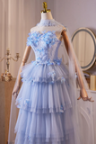 Light blue wedding dress with floral details on a mannequin against a neutral background.