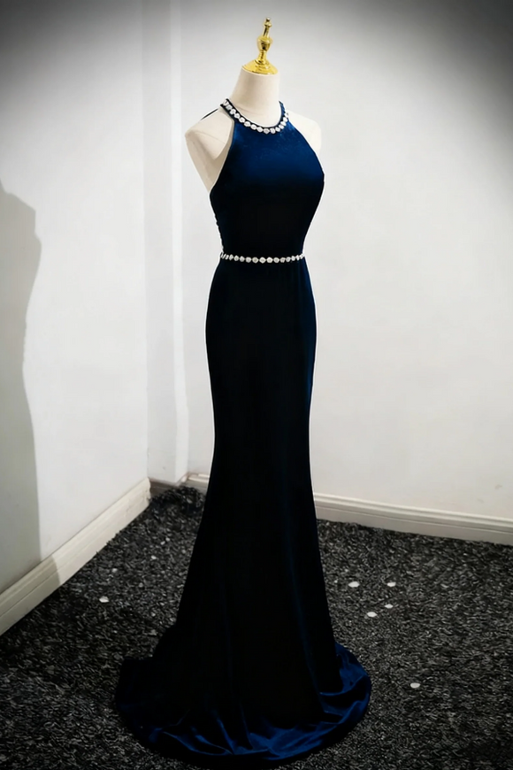 Navy blue evening gown on a mannequin against a white wall.