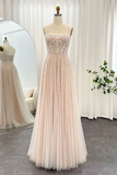 Blush pink evening gown with beaded top on a mannequin against a white curtain background.