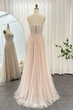Beige evening gown on a mannequin with a mirror reflection in a room setting.
