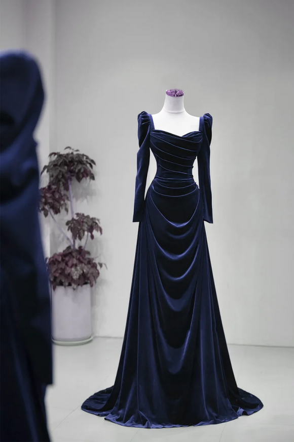 Navy blue velvet evening gown on a mannequin against a plain background