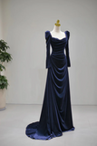 Navy blue velvet evening gown on a mannequin against a plain background