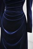 Navy blue velvet dress with long sleeves on a light gray background