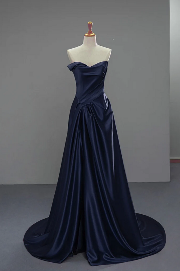 Navy blue evening gown on a mannequin against a plain background