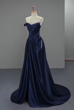Navy blue evening gown on a mannequin against a plain background