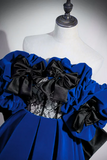 Blue dress with black ruffles on a mannequin against a white background