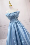 Light blue evening gown with a large bow on a mannequin against a white background