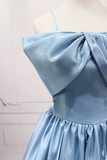 Light blue dress with a large bow detail on a mannequin against a white background