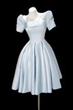 Light blue dress on a mannequin against a black background