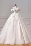 White wedding dress on a mannequin against a light-colored wall.