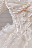 Close-up of a white wedding dress with intricate details and lace.