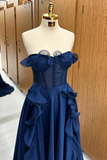 Navy blue evening gown on a mannequin against a wooden wardrobe background