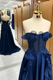 Navy blue evening gown on a mannequin in a fitting room.