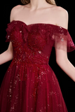 Red off-shoulder dress with sequin details on a black background