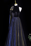 Black velvet dress with blue and gold accents on a mannequin against a black background