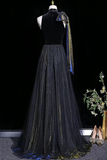 Black evening gown on a mannequin with a dark background