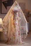 Floral dress on a mannequin with a sheer overlay in a room setting.