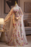 Mannequin wearing a floral dress with a sheer overlay in a room setting.