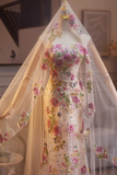 Floral dress with a veil on a mannequin against a neutral background