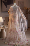 Elegant floral embroidered dress on a mannequin in a room setting.
