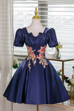 Navy blue dress with floral embroidery on a mannequin against a neutral background