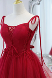 Red lace-up dress on a mannequin with a blurred background