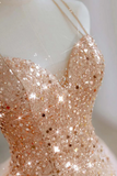 Rose gold glitter dress on a mannequin with a blurred background