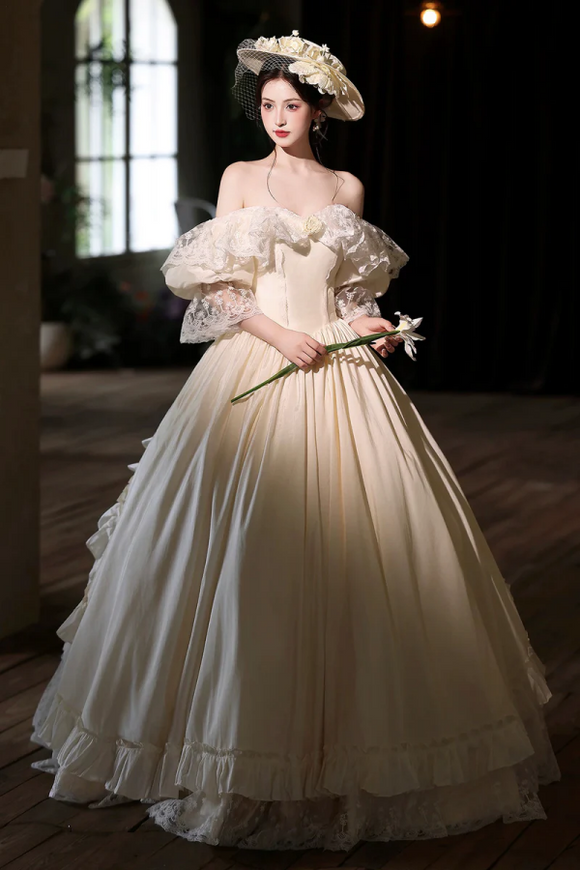 Woman in a white vintage dress holding flowers indoors