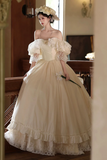 Woman in a vintage-style wedding dress with floral details in an elegant interior setting.